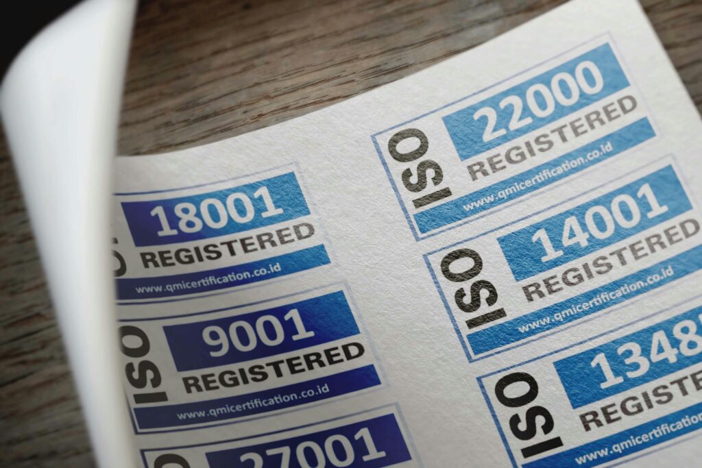 ISO certification stickers with registration numbers on paper.